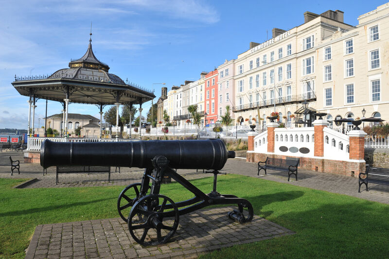 Cobh promenade bandstand and cannon with Commodore Hotel terrace behind
