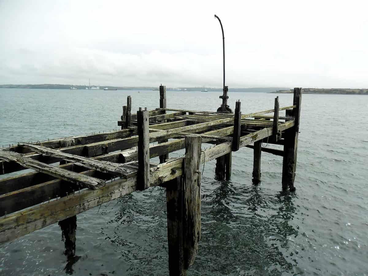 Weathered wooden pier remains over Cork Harbour